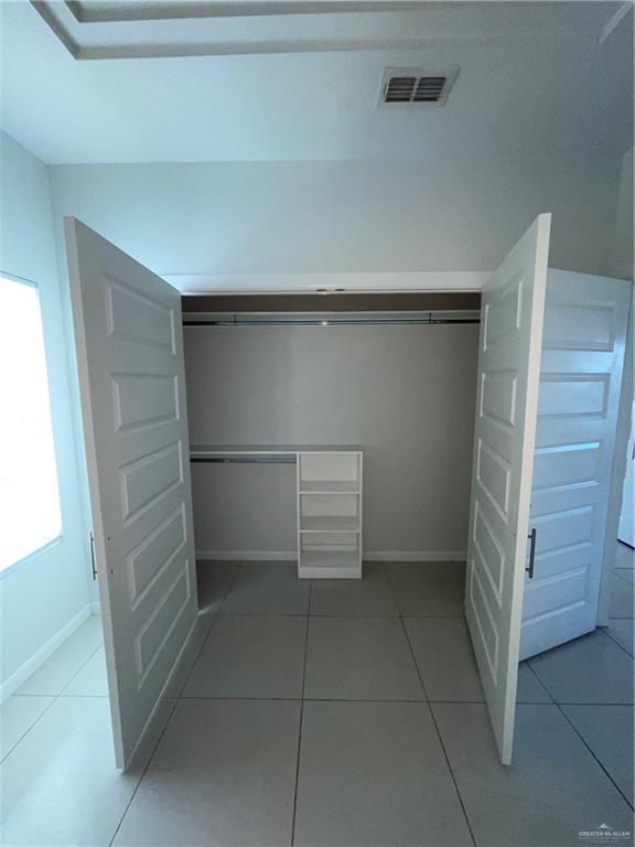 404 Rafael Drive, Unit 1 San Juan, TX 78589 - Photo 9 of 16 a view of walk in closet with empty racks