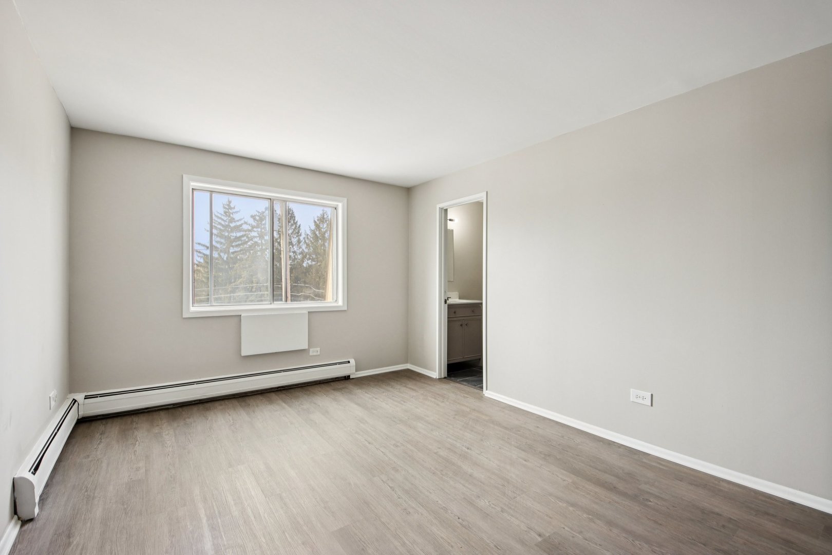 1111 Bloomingdale Road, Unit 2A Glendale Heights, IL 60139 - Photo 12 of 26 an empty room with wooden floor and windows