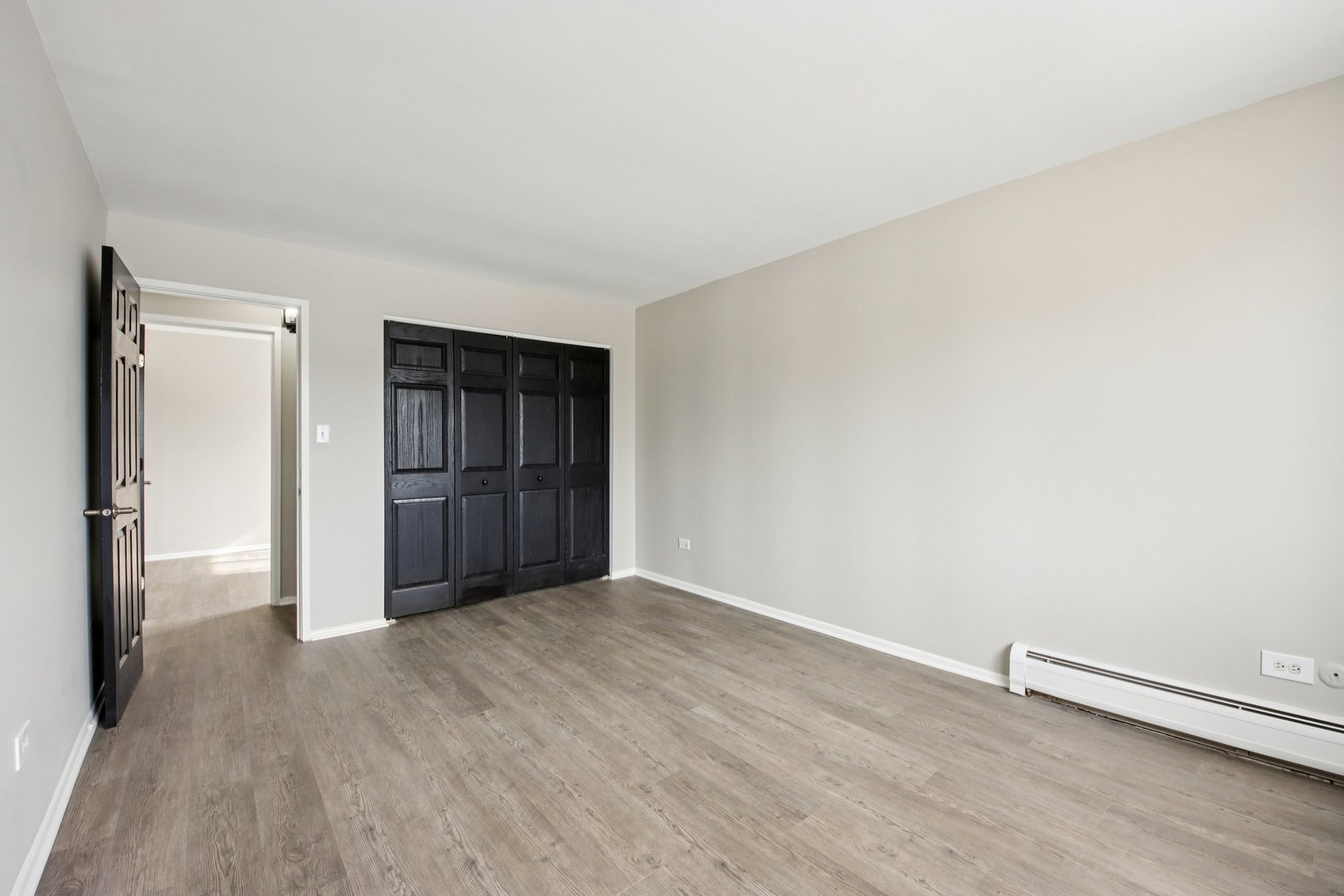 1111 Bloomingdale Road, Unit 2A Glendale Heights, IL 60139 - Photo 13 of 26 a view of an empty room with wooden floor and closet