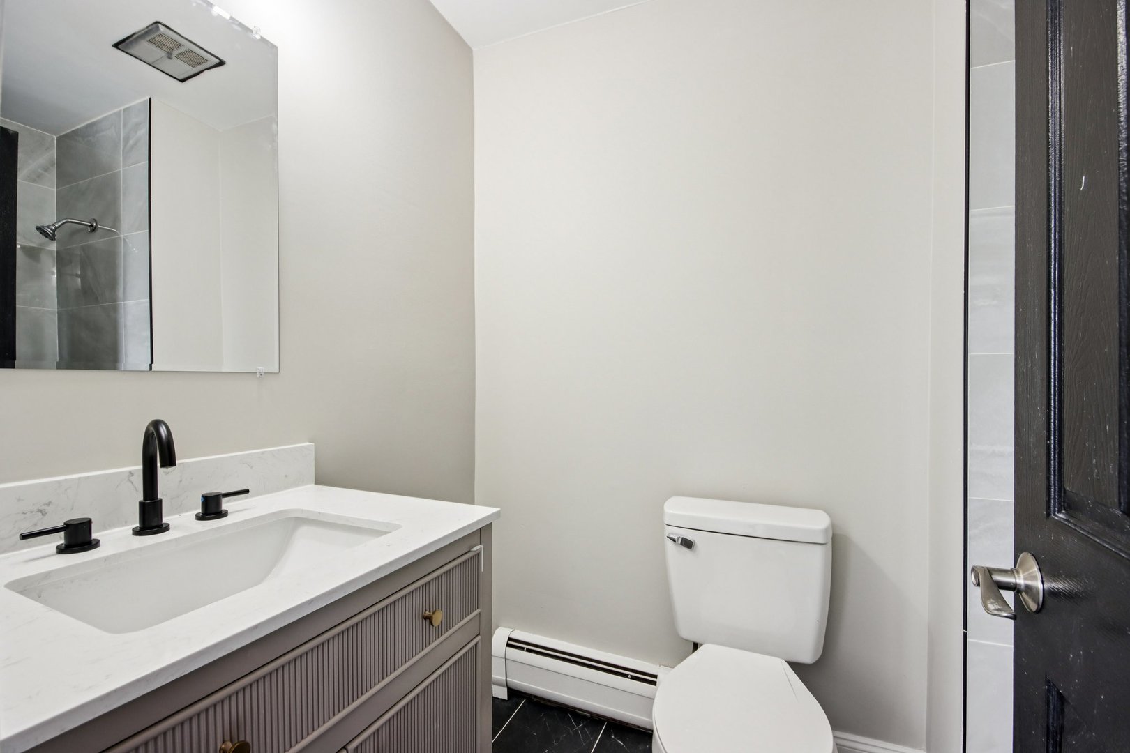 1111 Bloomingdale Road, Unit 2A Glendale Heights, IL 60139 - Photo 15 of 26 a bathroom with a toilet sink and mirror