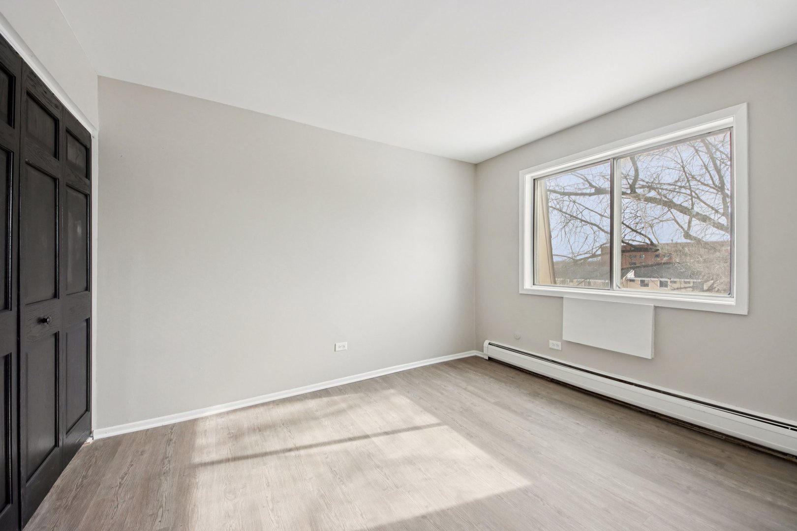 1111 Bloomingdale Road, Unit 2A Glendale Heights, IL 60139 - Photo 18 of 26 an empty room with windows