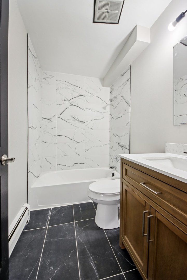 1111 Bloomingdale Road, Unit 2A Glendale Heights, IL 60139 - Photo 20 of 26 a bathroom with a toilet a sink and shower