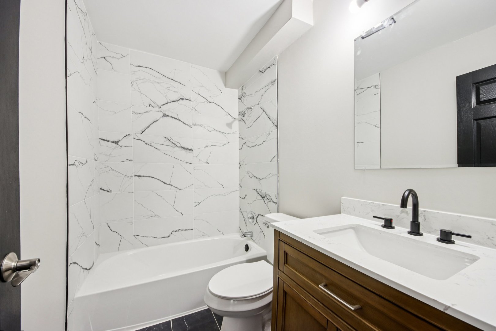 1111 Bloomingdale Road, Unit 2A Glendale Heights, IL 60139 - Photo 21 of 26 a bathroom with a sink a toilet and a bathtub