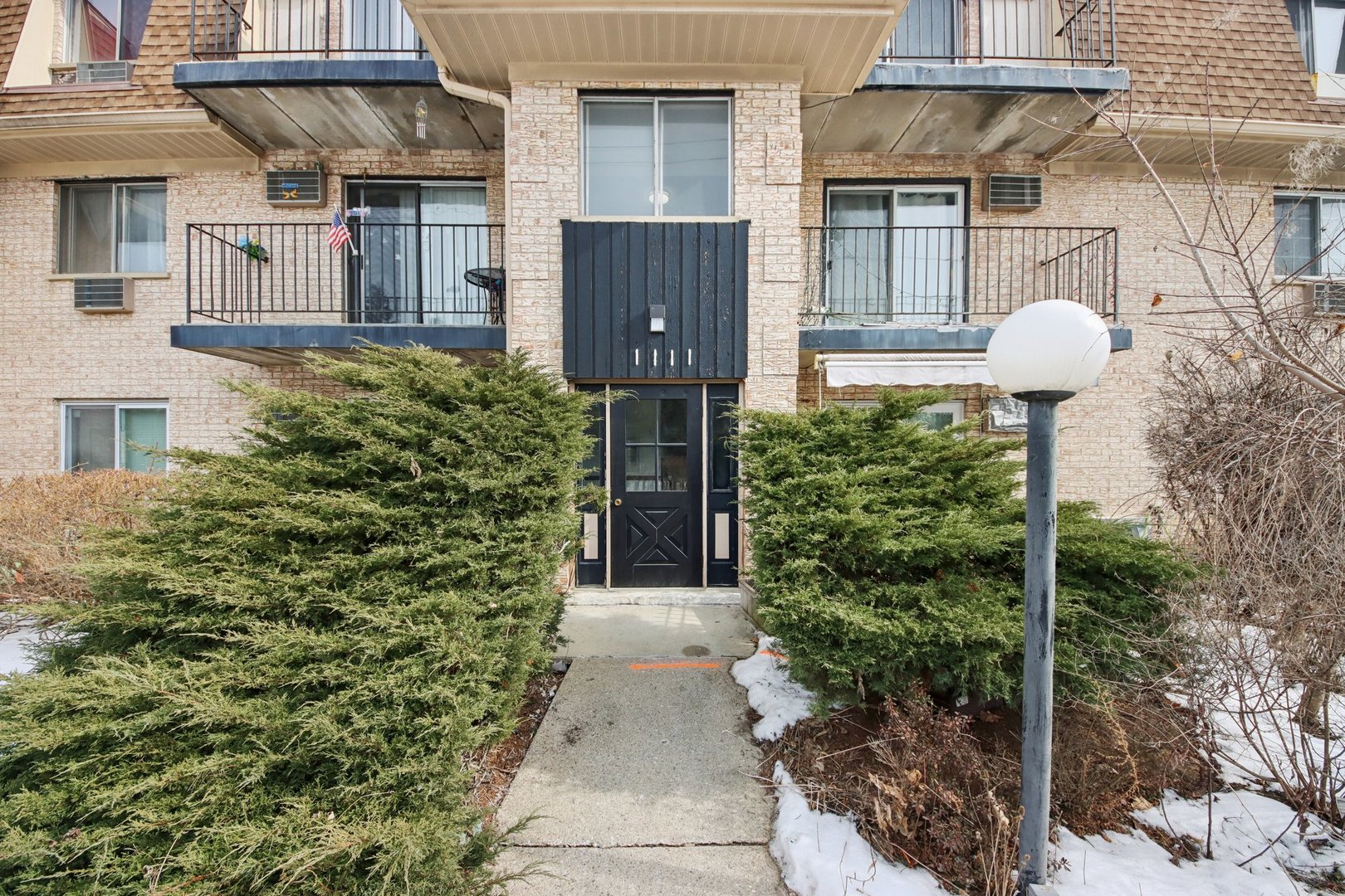 1111 Bloomingdale Road, Unit 2A Glendale Heights, IL 60139 - Photo 23 of 26 a front view of a house with garden