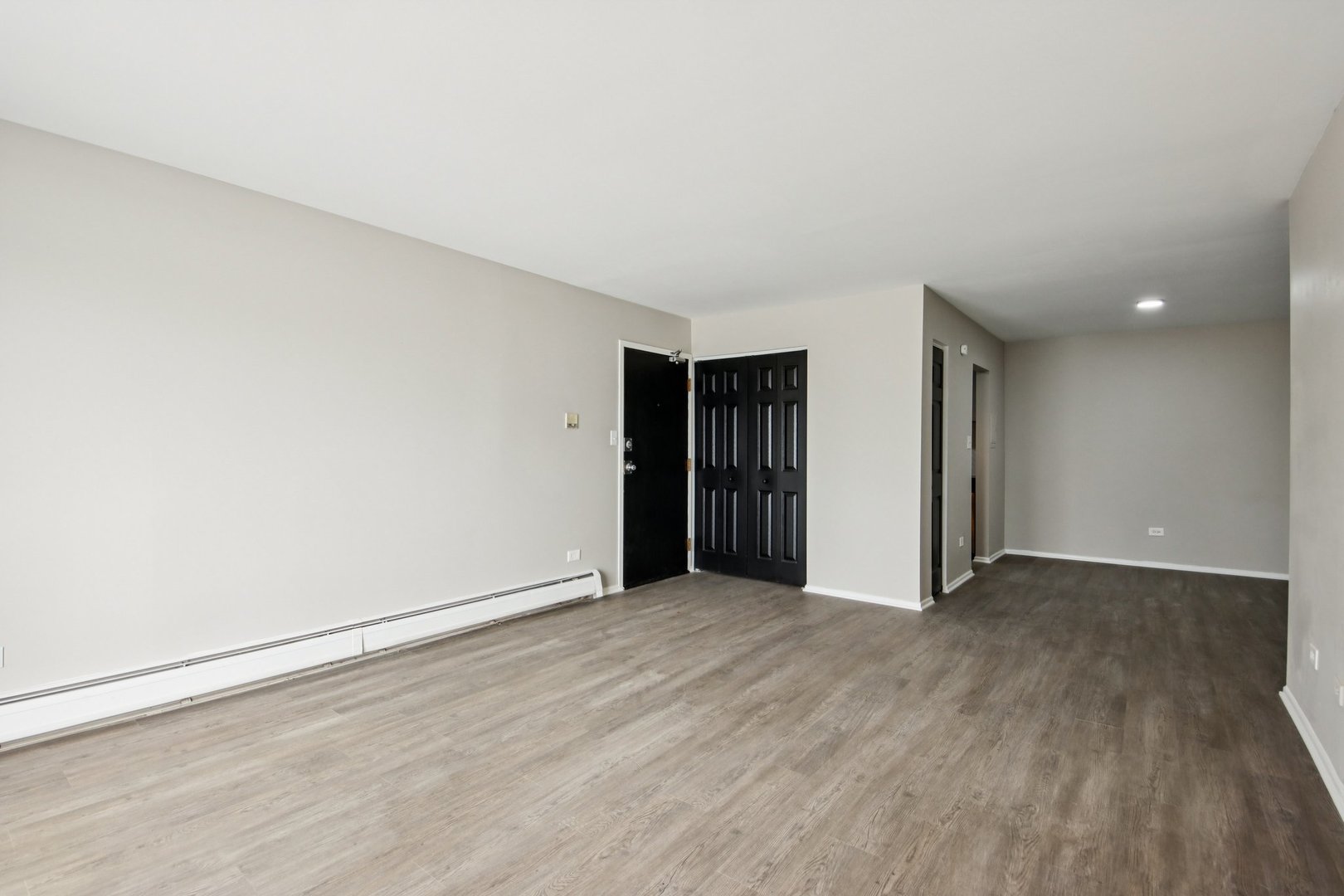 1111 Bloomingdale Road, Unit 2A Glendale Heights, IL 60139 - Photo 5 of 26 a view of an empty room with wooden floor