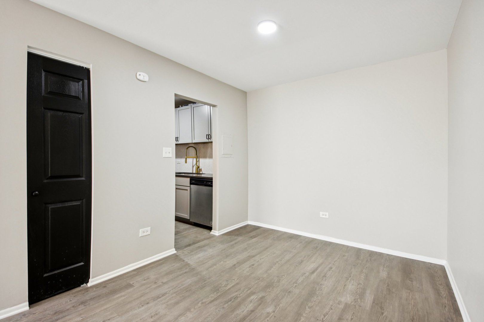1111 Bloomingdale Road, Unit 2A Glendale Heights, IL 60139 - Photo 6 of 26 a view of kitchen and empty room with wooden floor