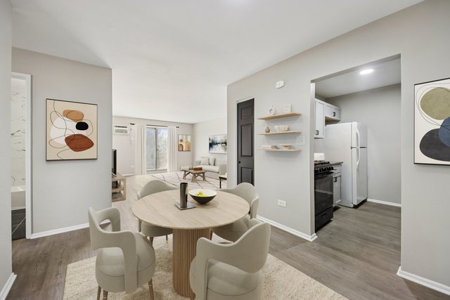 1111 Bloomingdale Road, Unit 2A Glendale Heights, IL 60139 - Photo 7 of 26 a kitchen with a dining table and chairs