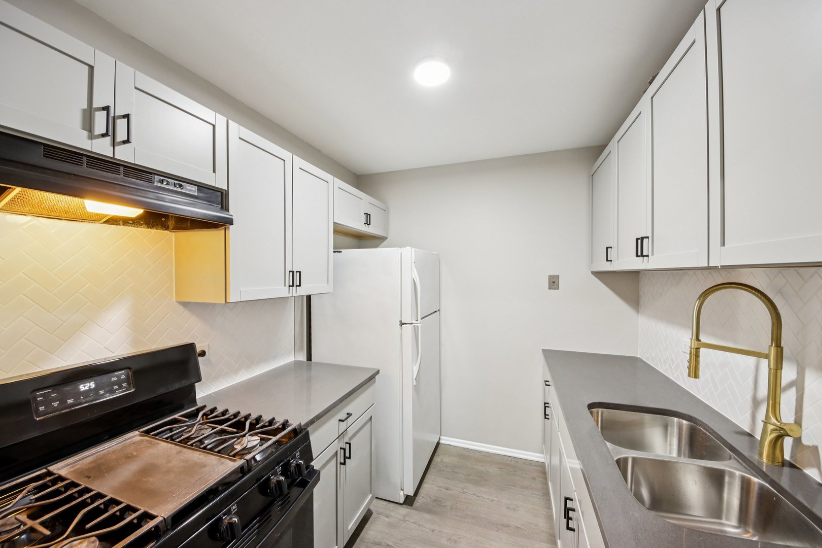 1111 Bloomingdale Road, Unit 2A Glendale Heights, IL 60139 - Photo 9 of 26 a kitchen with stainless steel appliances granite countertop a stove a refrigerator and a sink