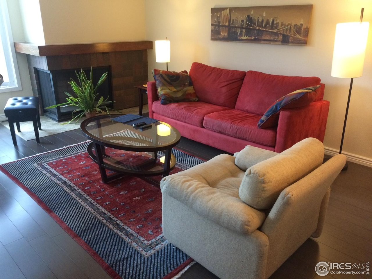 1209 Harrison Court Boulder, CO 80303 - Photo 12 of 35 a living room with furniture a rug and a lamp