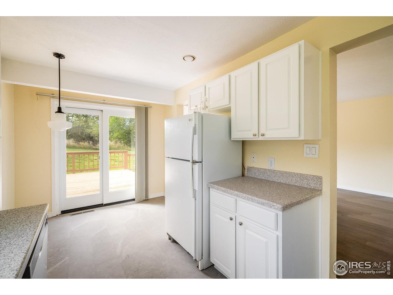 1209 Harrison Court Boulder, CO 80303 - Photo 18 of 35 a kitchen with stainless steel appliances granite countertop a refrigerator a sink and a view of living room