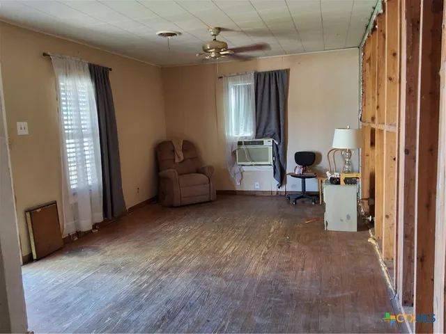 a view of a livingroom with furniture and a window