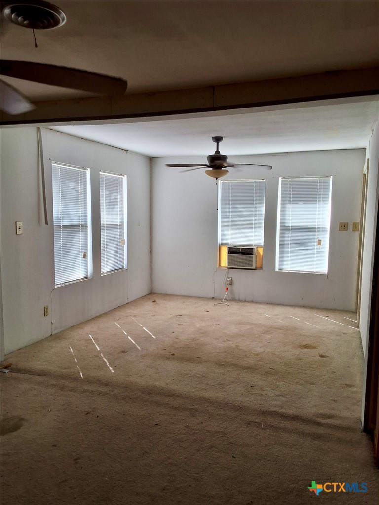 609 East Sarah Street Cuero, TX 77954 - Photo 8 of 14 a view of an empty room with a window