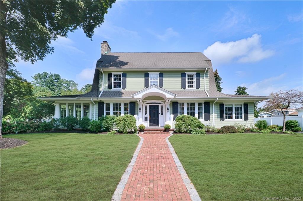 Brick front walk leads to this gracious Dutch colonial, a recipient of Fairfield's "Pride in Your Home" Landscaping Contest .