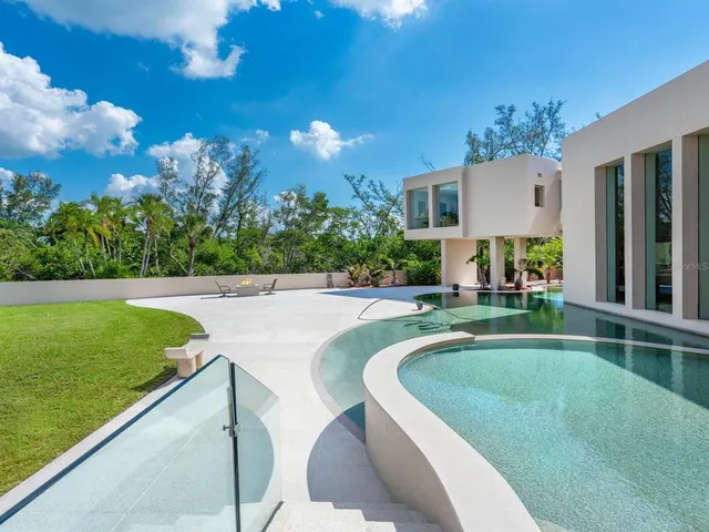 a spacious bedroom with a bed couch and a large window