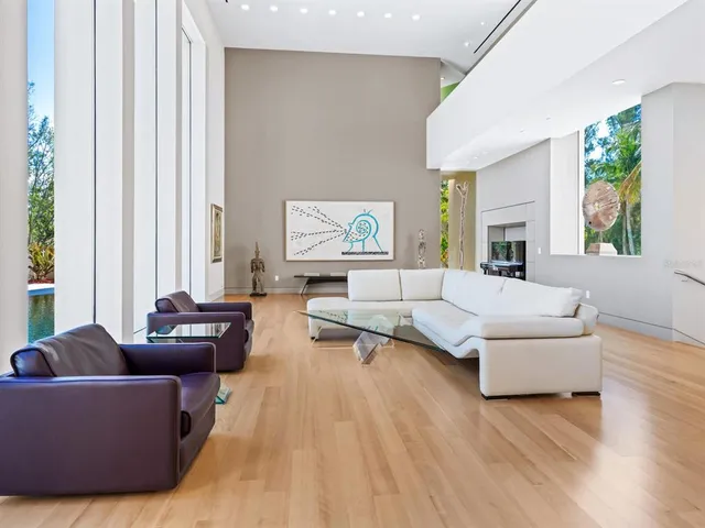 a living room with patio furniture and a large window