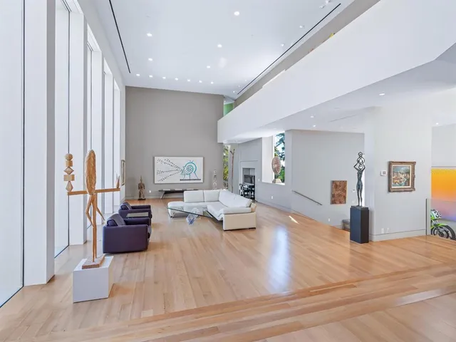 a bedroom with a large bed and a large window