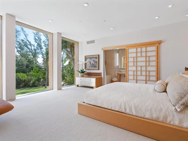 a view of a white house with a yard and sitting area