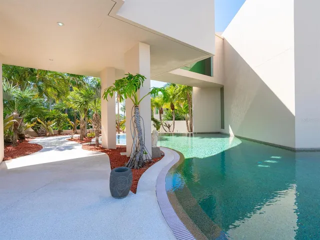 a backyard of a house with table table and chairs