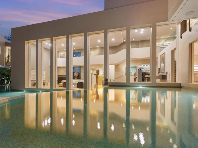 an aerial view of a house with a swimming pool yard and outdoor seating