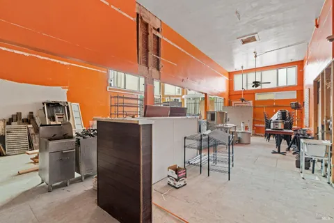 a living room with furniture a flat screen tv and next to a window