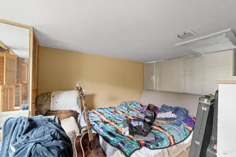 a bed sitting in a bedroom next to a window