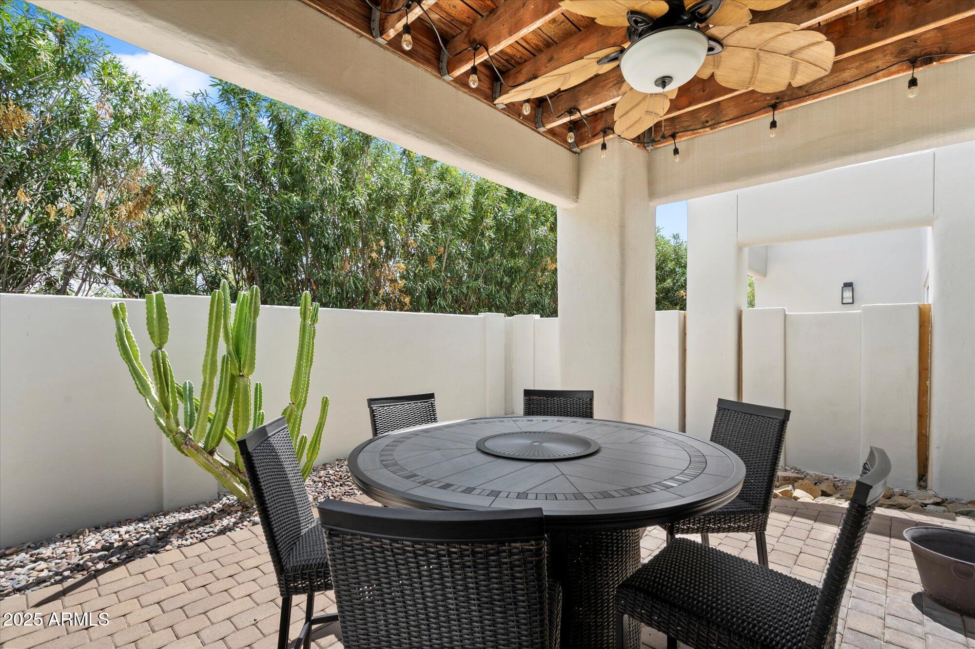 7710 East Gainey Ranch Road, Unit 139 Scottsdale, AZ 85258 - Photo 26 of 38 a view of a table and chairs in patio