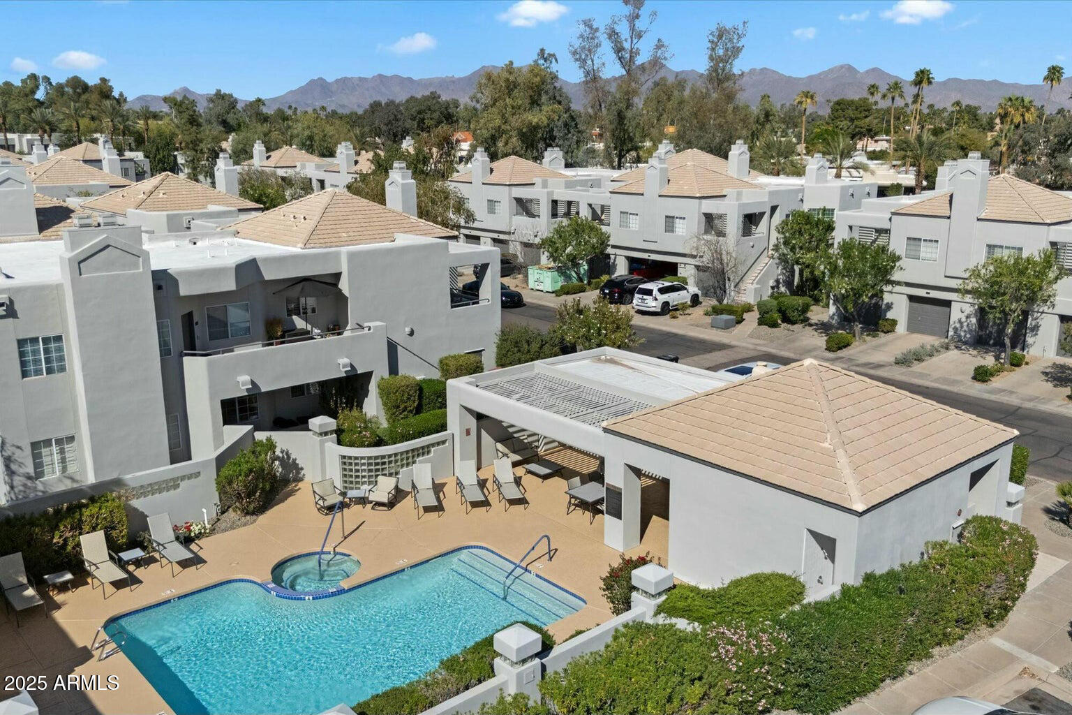 7710 East Gainey Ranch Road, Unit 139 Scottsdale, AZ 85258 - Photo 34 of 38 an aerial view of a house with swimming pool and mountain view
