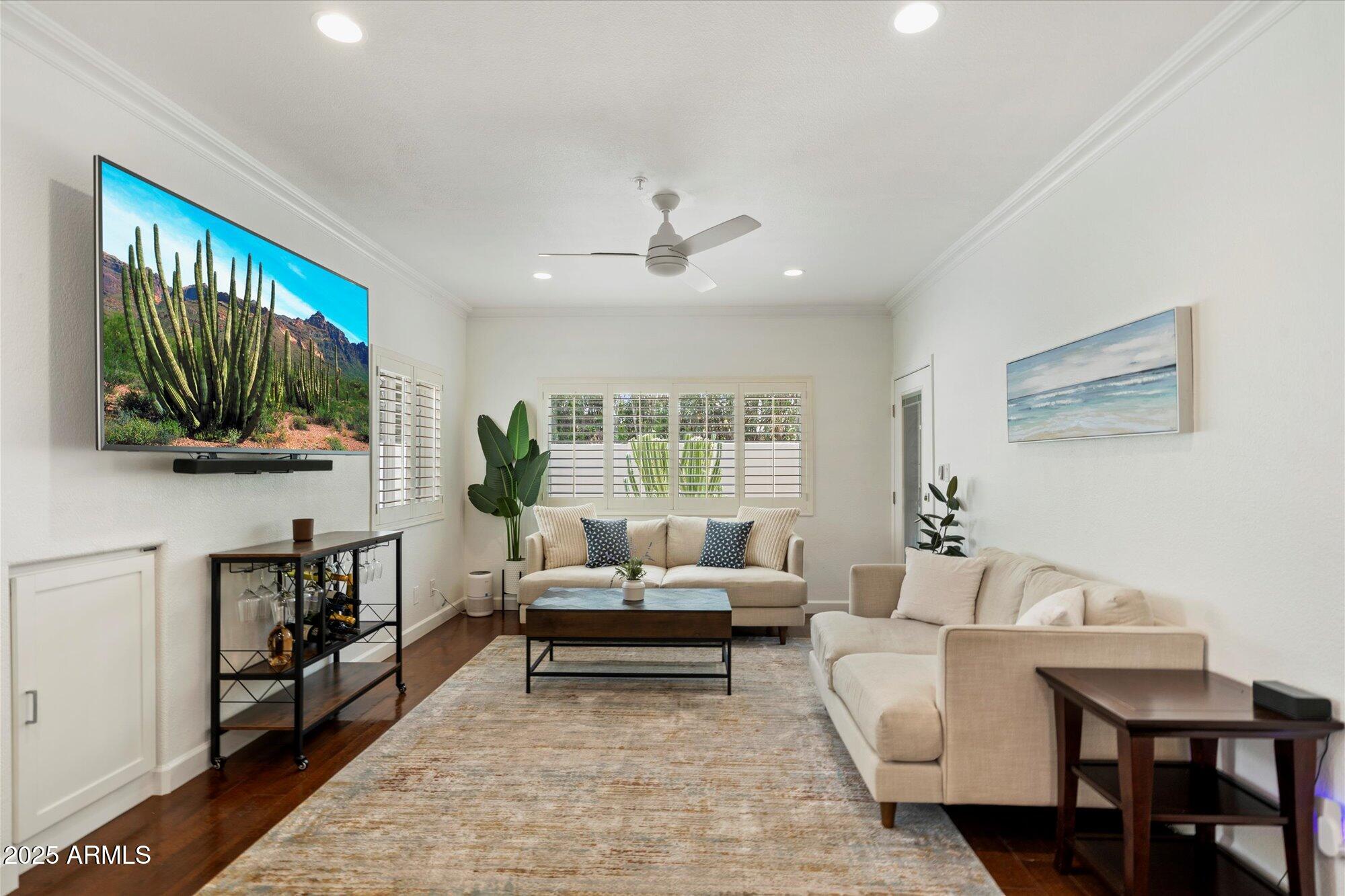 7710 East Gainey Ranch Road, Unit 139 Scottsdale, AZ 85258 - Photo 7 of 38 a living room with furniture a flat screen tv and a window