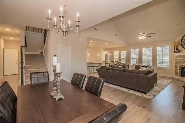 a living room with furniture kitchen view and a chandelier