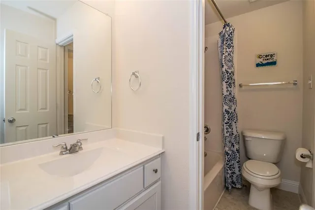 a bathroom with a double vanity sink mirror and shower
