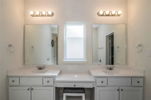 a spacious bathroom with a shower a sink and a mirror