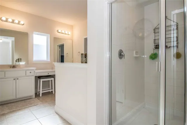 a bathroom with a tub a sink and a mirror