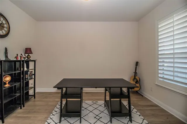 a view of a room with furniture and wooden floor