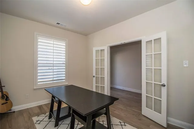 a view of a workspace with furniture and a window