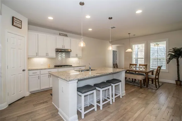 a kitchen with kitchen island granite countertop a sink and counter space