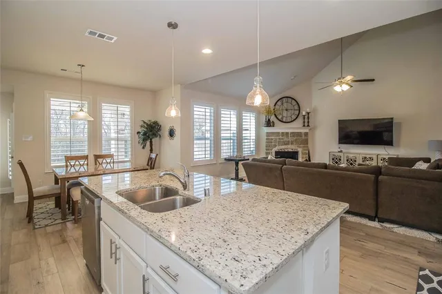 a kitchen with a sink a stove a refrigerator and cabinets