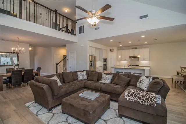 a kitchen with granite countertop a sink a counter top space and stainless steel appliances