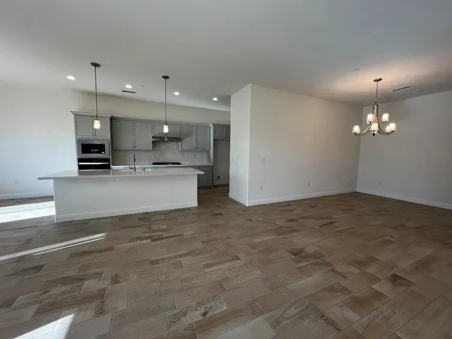 a kitchen with kitchen island a sink stainless steel appliances and cabinets