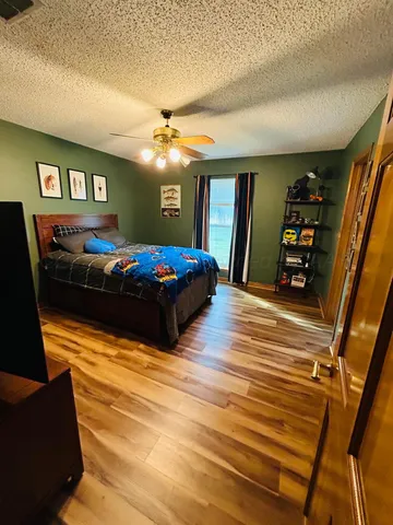 a bedroom with bed and a chandelier