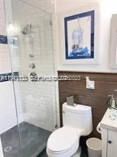 a white toilet sitting next to a bathroom sink
