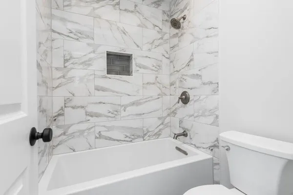 a bathroom with a bathtub and a toilet