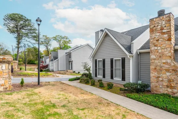 a view of a house with small yard and plants