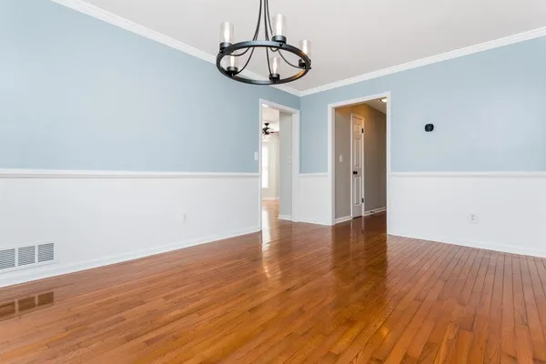 a view of a room with wooden floor and window