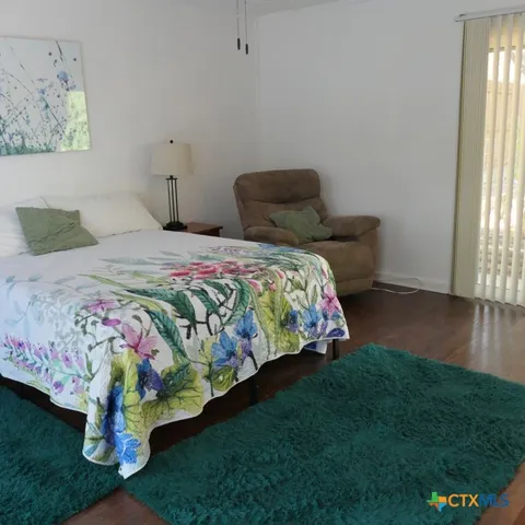 a blue bed sitting in a room next to a window