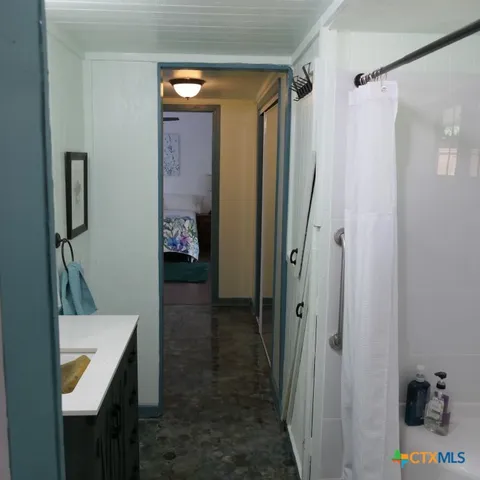 a bathroom with a sink a toilet and mirror