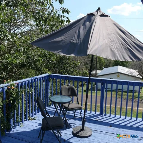 a view of balcony with wooden floor and outdoor seating