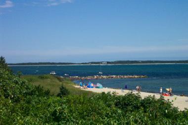 Undisclosed Address Hyannis, MA 02601 - Photo 2 of 2 an aerial view of a city with lots of residential buildings and ocean view in back