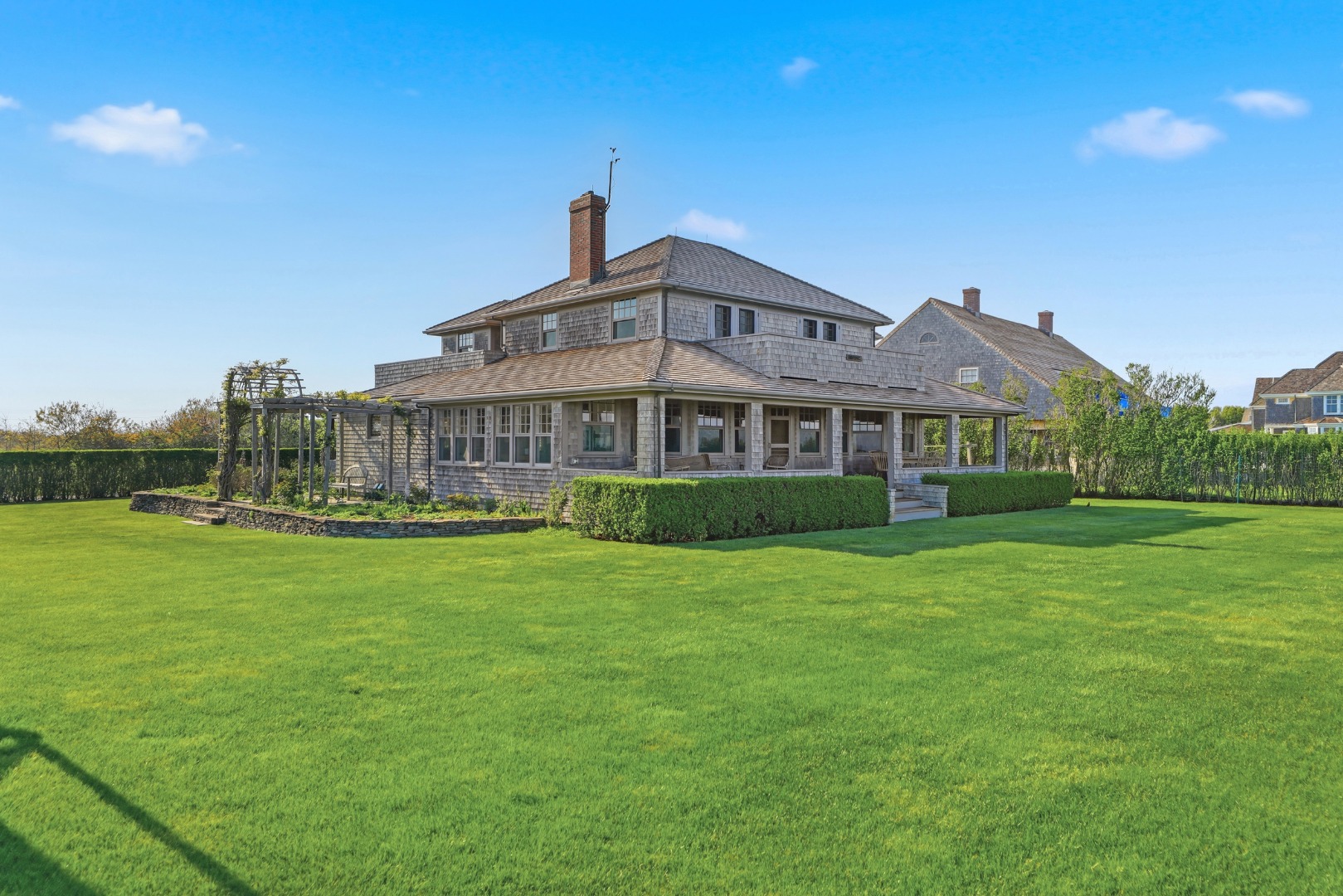 59 Baxter Road Nantucket, MA 02554 - Photo 7 of 8 a front view of a house with a garden