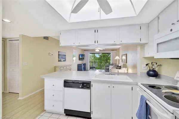 a kitchen with a sink a stove and cabinets