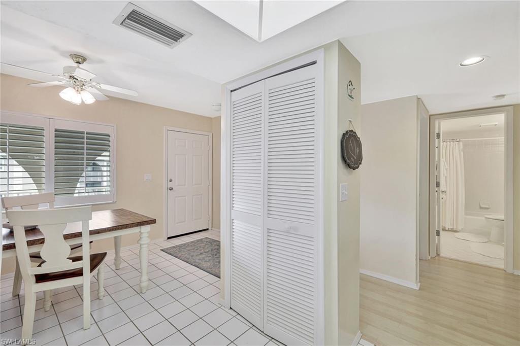 234 Pebble Beach Boulevard, Unit 306 Naples, FL 34113 - Photo 14 of 19 a view of kitchen with furniture and wooden floor
